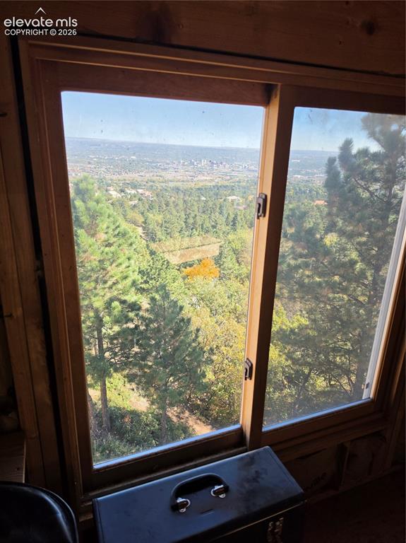 Image 38 of 38: Wood-framed window offering expansive distant scenery