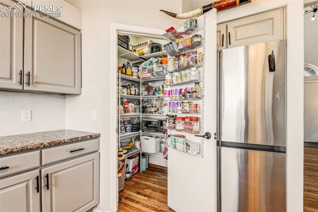 Image 10 of 45: Kitchen with stainless appliances, granite counter tops, walk in pantry and