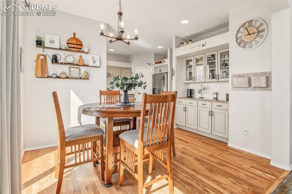 Image 14 of 45: Dining room with a walk out to the back deck plus butler bar