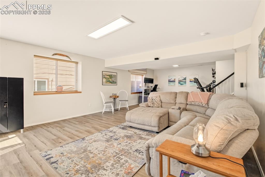 Image 31 of 45: Recreation room with walk out to dug run, backyard and covered patio