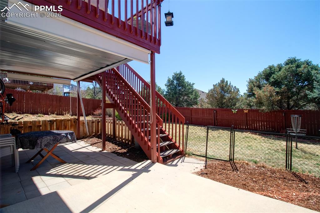 Image 32 of 45: Covered patio off lower level walk out (with water drainage system)
