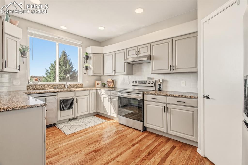 Image 7 of 45: Kitchen with stainless appliances, granite counter tops, walk in pantry and