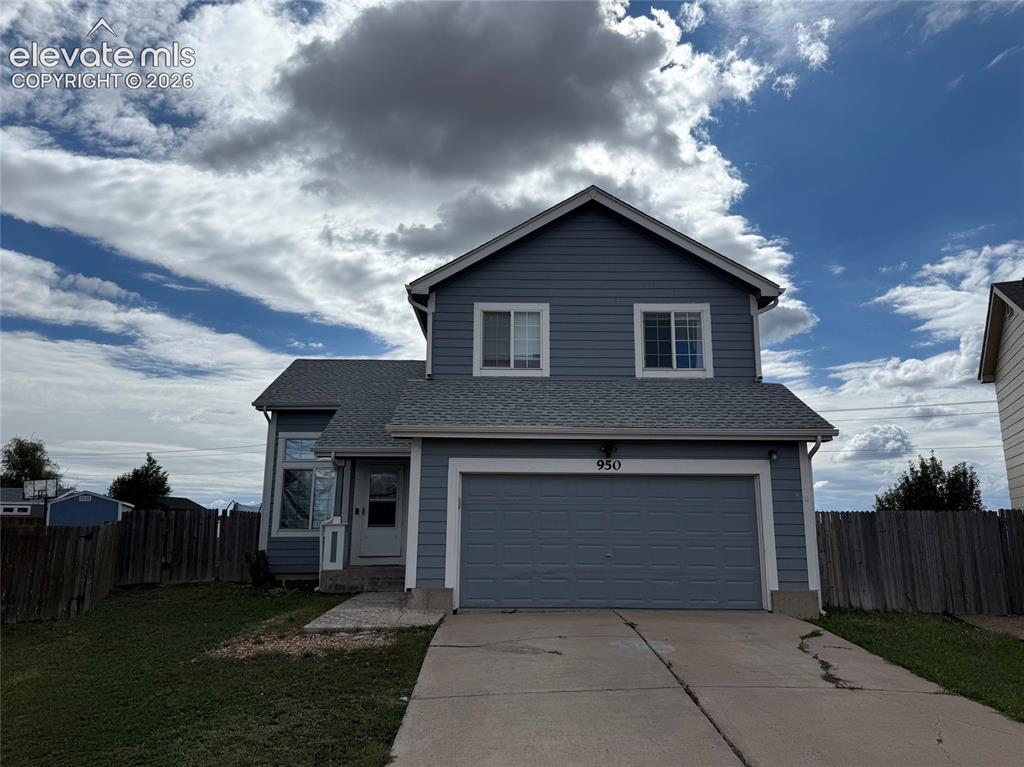 Caption: Two-story exterior with siding, attached two-car garage, front entry, and concrete driveway