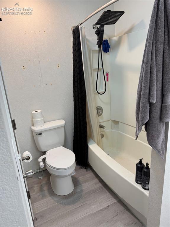 Image 13 of 21: Bathtub/shower combination with a matte black square rain shower head, whit