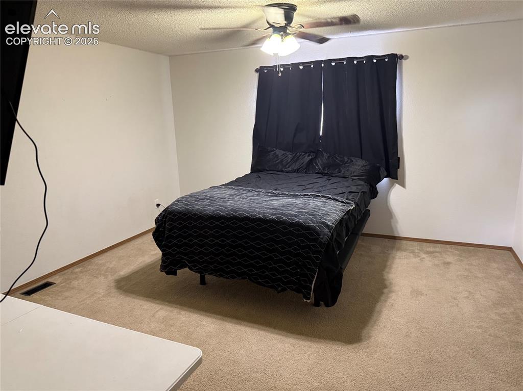 Image 9 of 21: Carpeted flooring with a ceiling fan light fixture