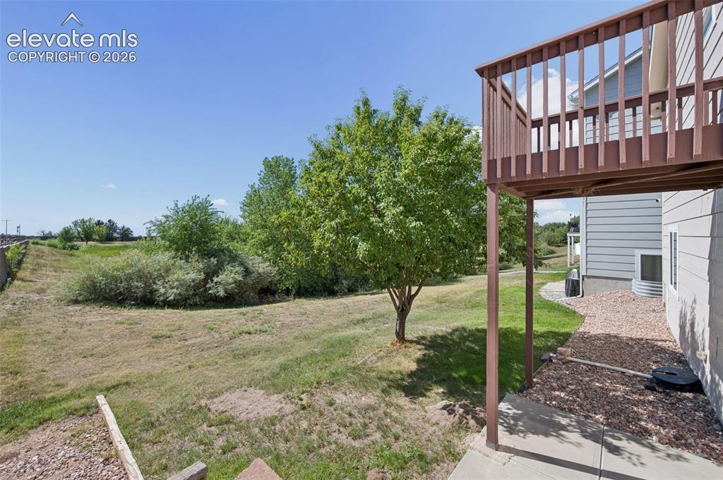 Image 30 of 37: Patio and Balcony from Master pointing to open Space
