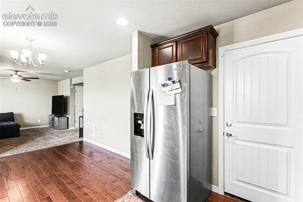 Image 13 of 27: Kitchen featuring stainless steel appliances, wood-finish flooring, recesse