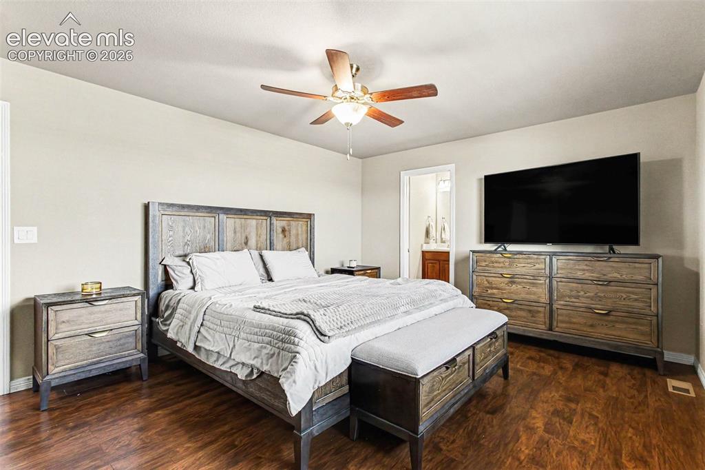 Image 14 of 27: Kitchen area featuring wood-finish flooring, dark wood cabinetry, a double