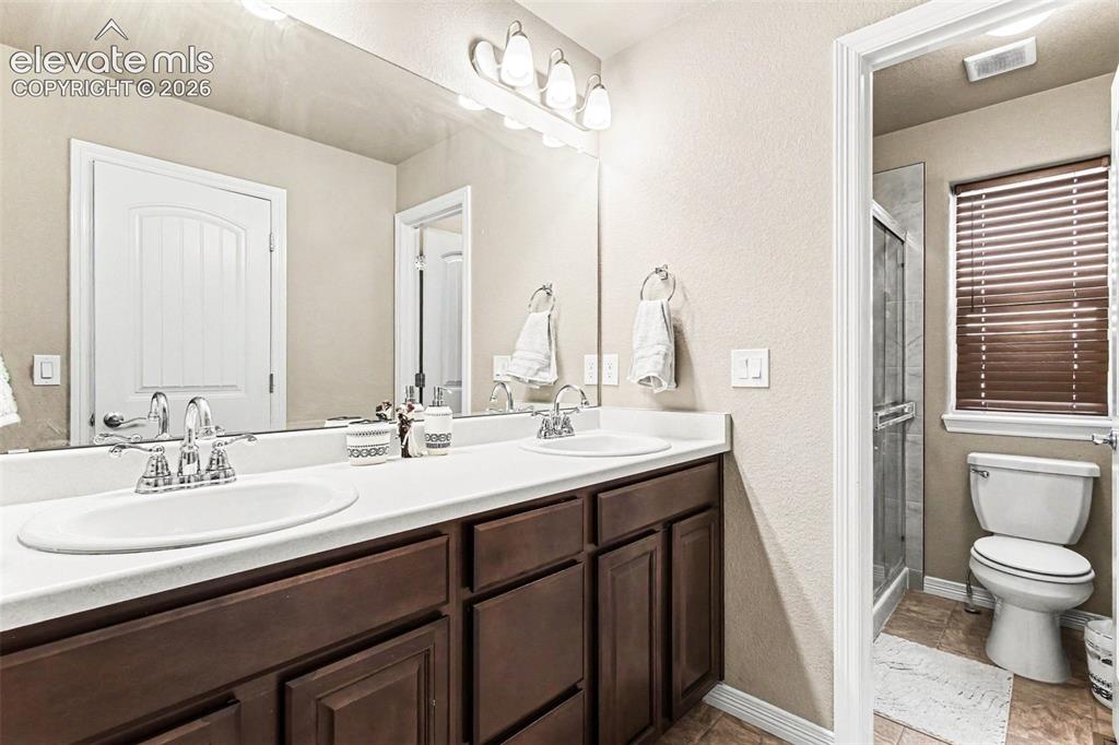 Image 17 of 27: Stainless steel refrigerator, wood-finish flooring, recessed lighting, whit
