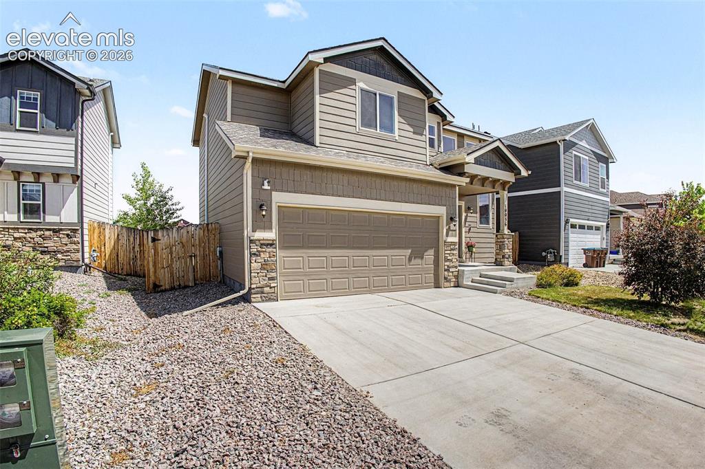 Image 2 of 27: Contemporary two-story residence with a concrete driveway and an attached t