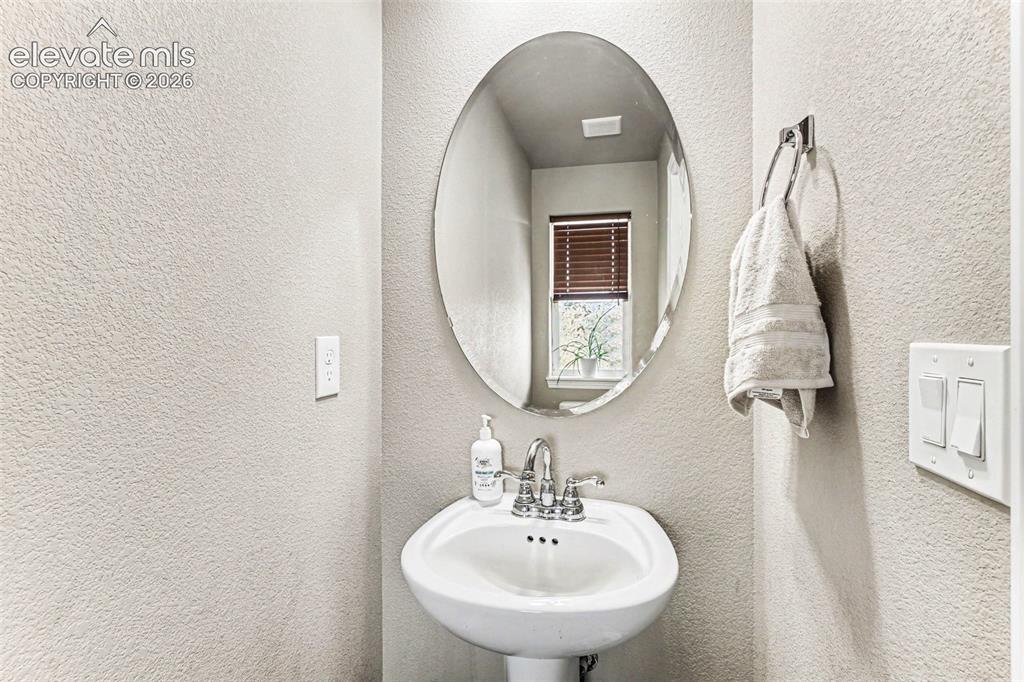 Image 20 of 27: Spacious bedroom featuring wood-finish flooring, a ceiling fan with integra