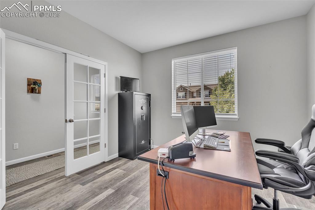 Image 13 of 50: Office space featuring light wood-style flooring and baseboards