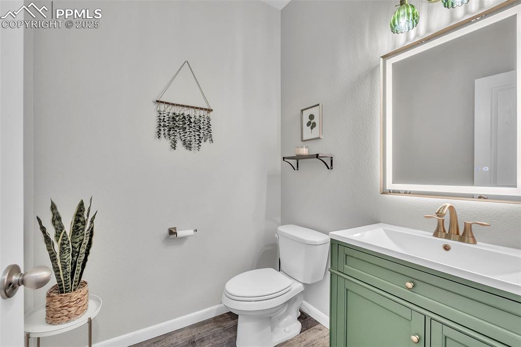 Image 14 of 50: Half bath featuring vanity and light wood-style flooring