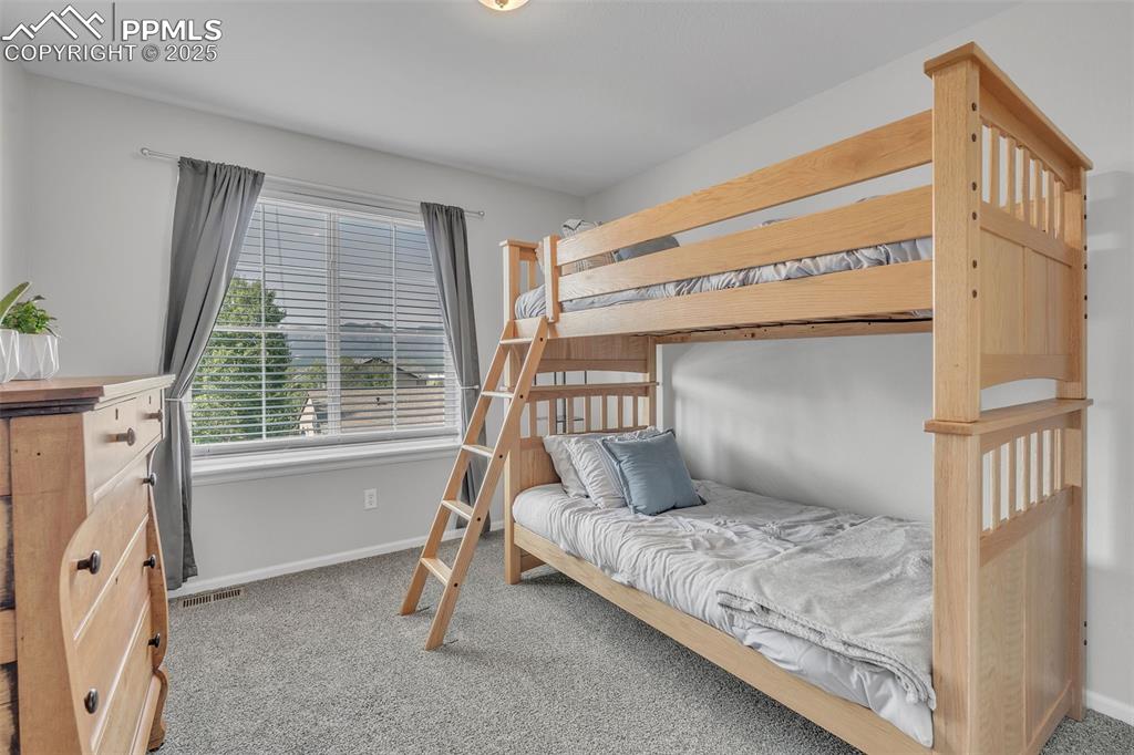 Image 18 of 50: Bedroom featuring light colored carpet and baseboards