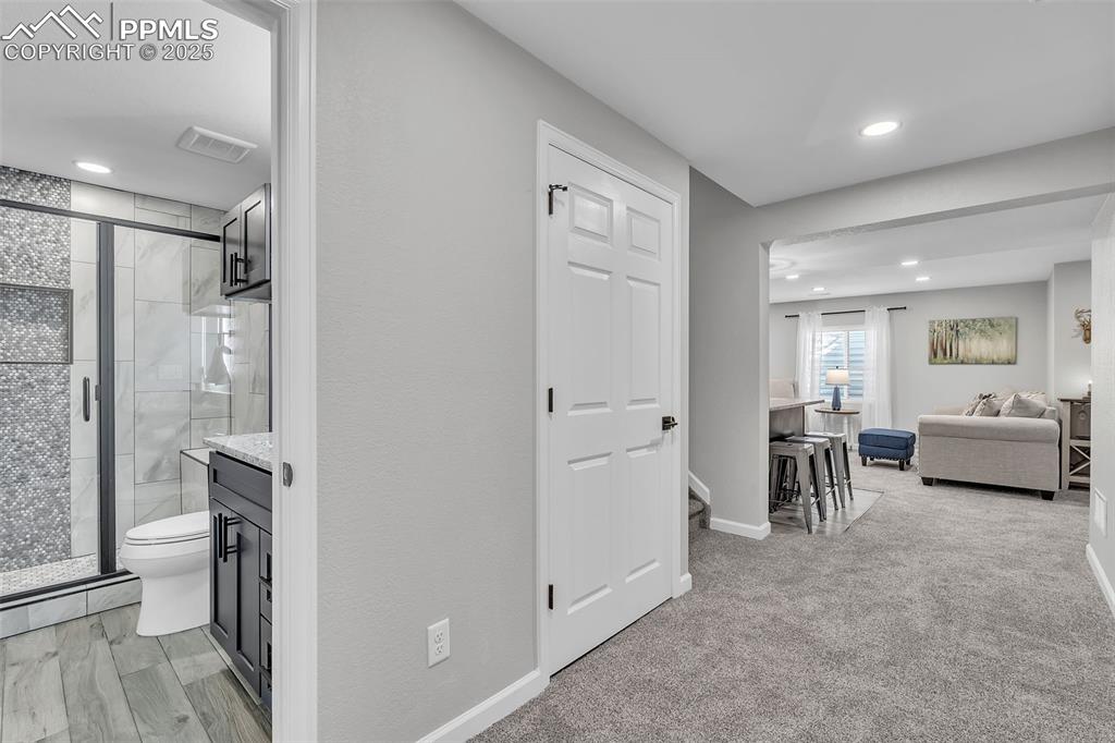 Image 37 of 50: Corridor featuring recessed lighting and light colored carpet
