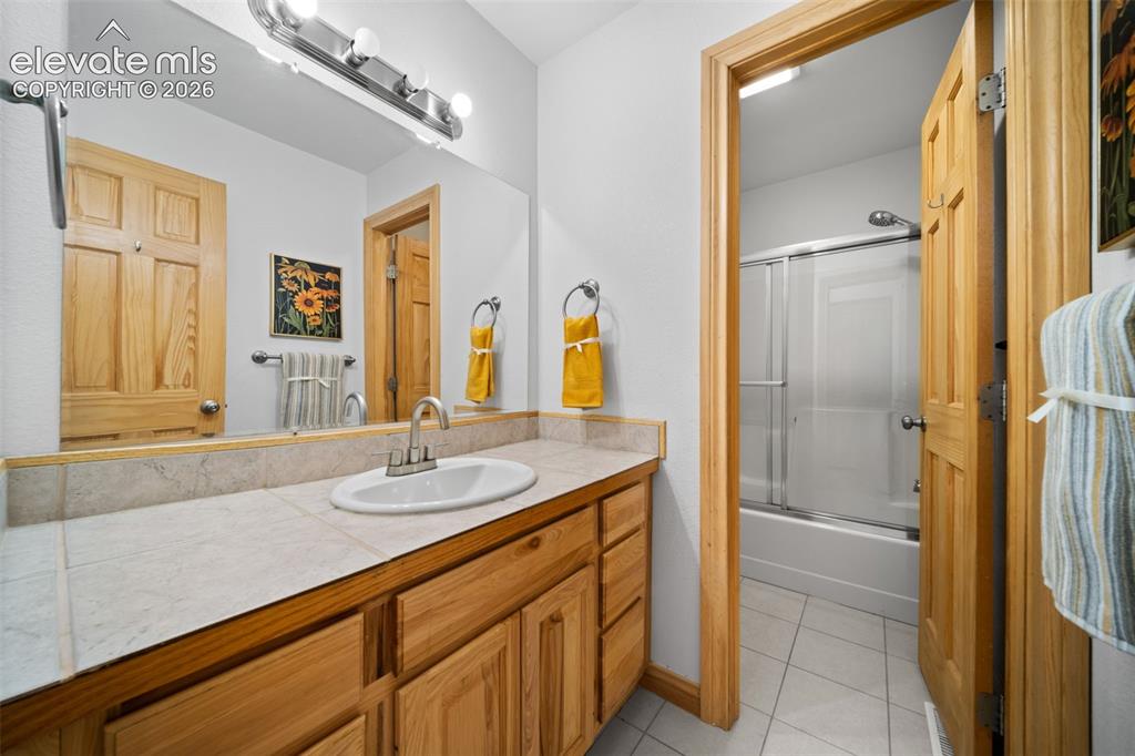Image 18 of 39: Main level bedroom with private access to the backyard patio