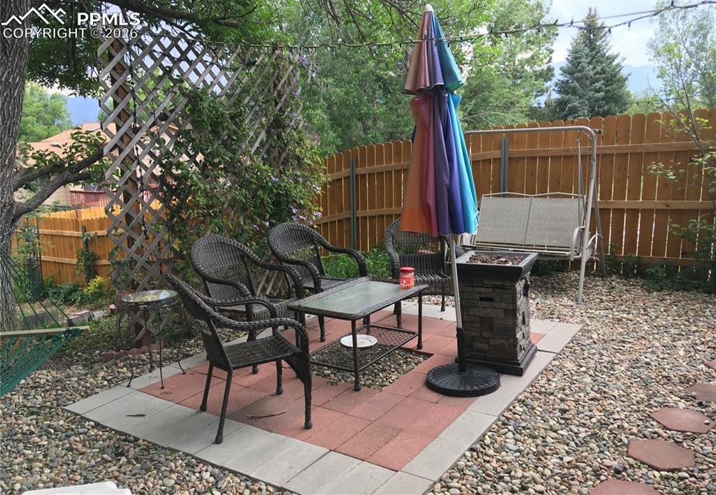Image 28 of 33: Covered back patio with hot tub that stays.
