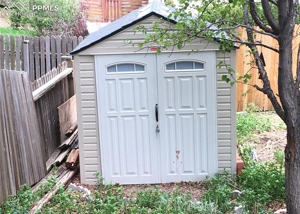 Image 30 of 33: Rear view of home. Hot tub is located on covered patio.