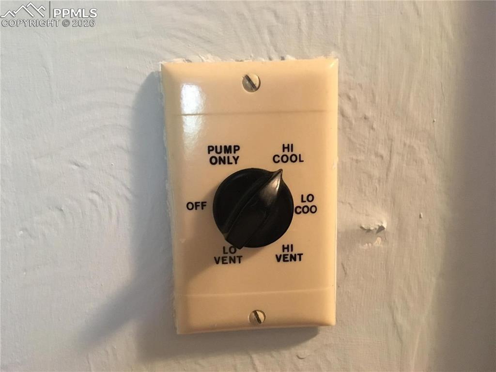 Image 31 of 33: Attractive patio area in the backyard is shaded by mature trees.