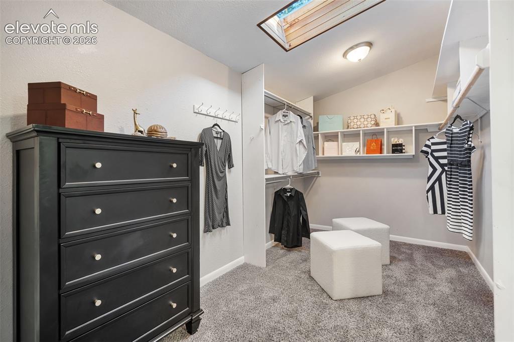 Image 10 of 21: Primary bedroom dressing area and closet