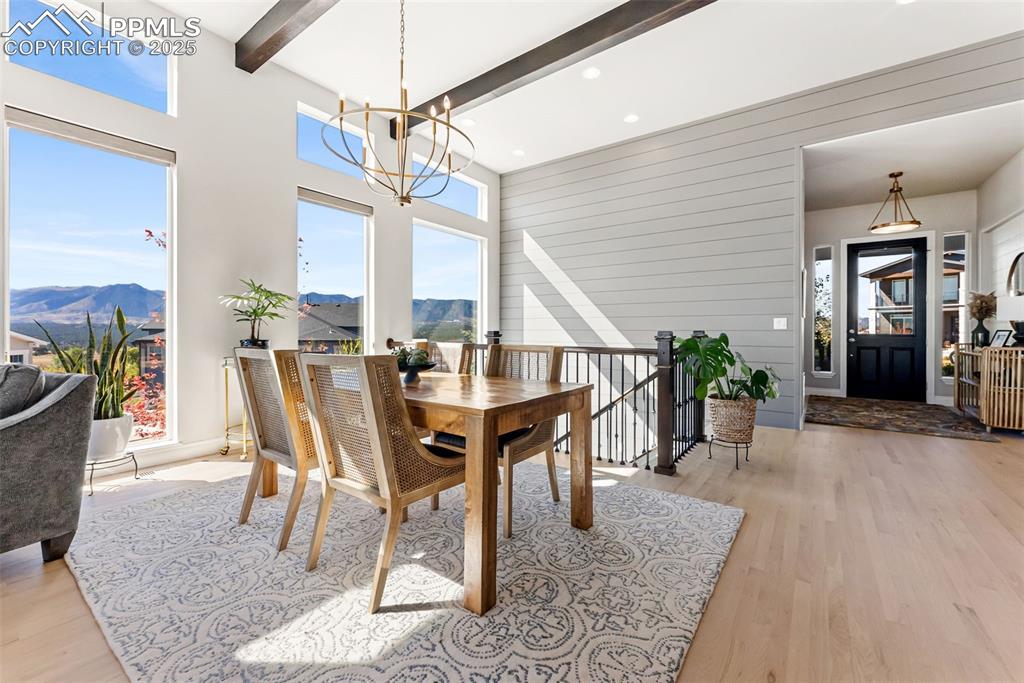 Image 12 of 50: The entry opens up to a bright dining area and stairs to the walk out basem