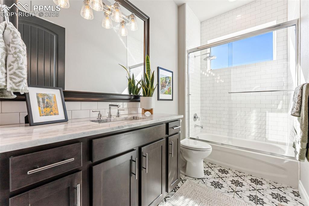 Image 29 of 50: Second main level bathroom with the same elegant finishes and hardware