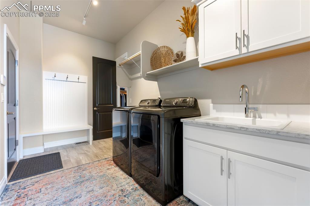 Image 30 of 50: Large laundry / mud area with access to the primary closet and garage. Buil