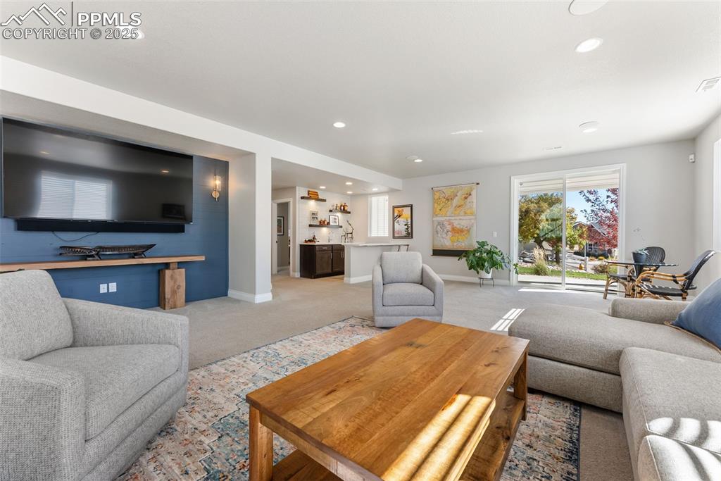 Image 34 of 50: Off the family room is a full wet bar and includes a wine cooler/refrigerat