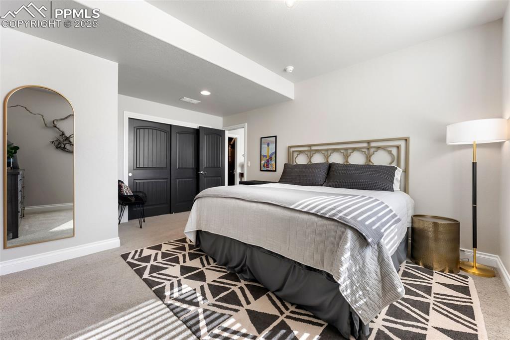 Image 38 of 50: Third bedroom on the basement level is large and bright