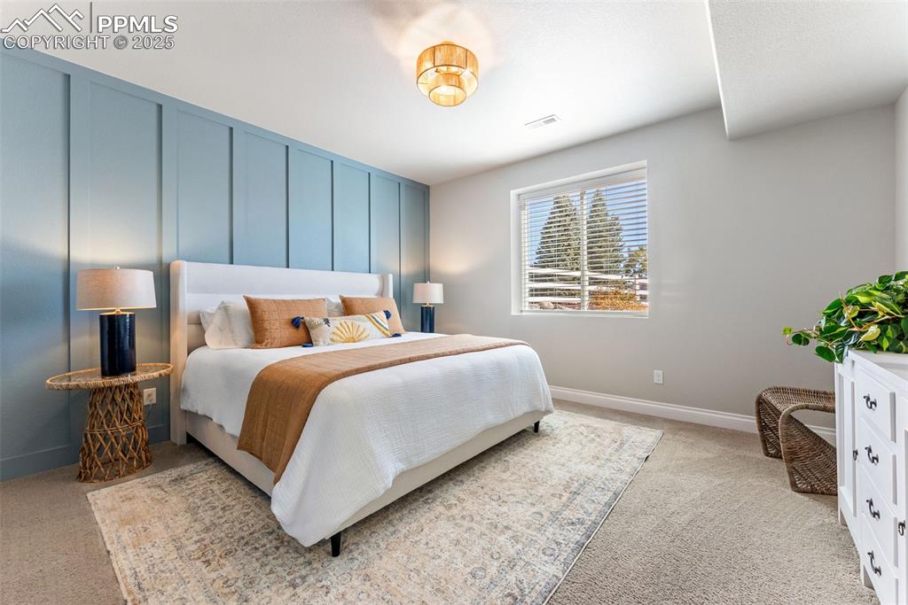 Image 40 of 50: Fourth bedroom is large in size and features a beautiful accent wall