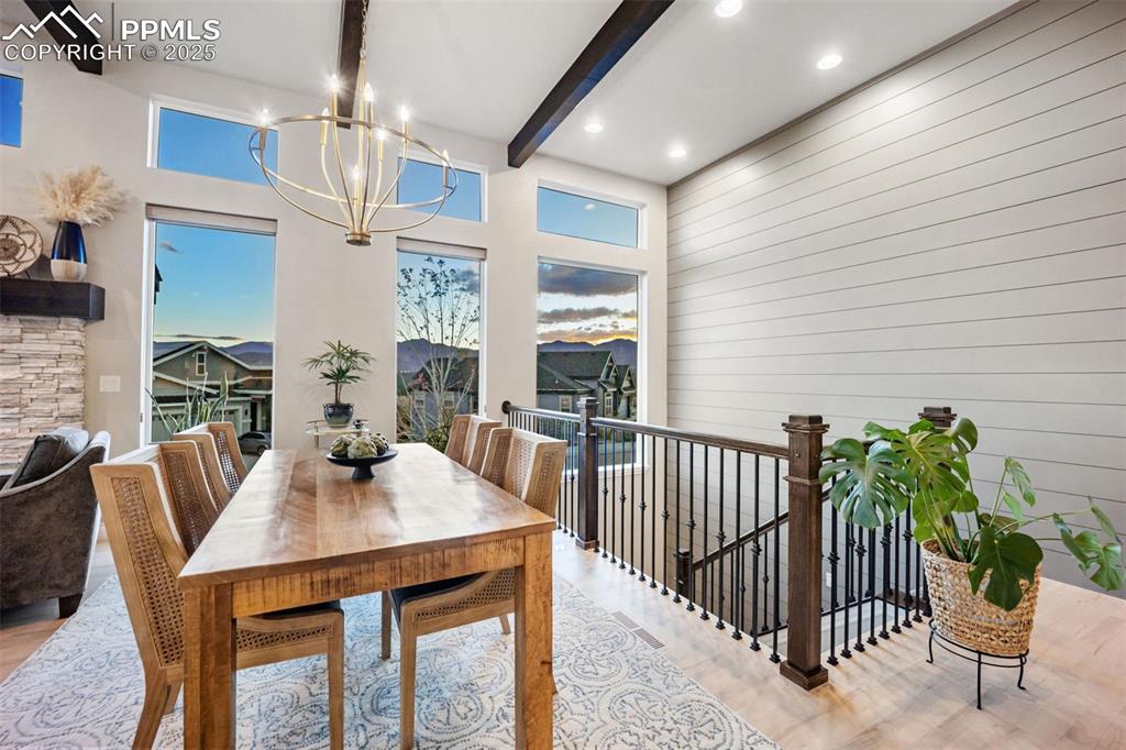 Image 5 of 50: Open front entry leads to a dining area with views and stairs to the walkou