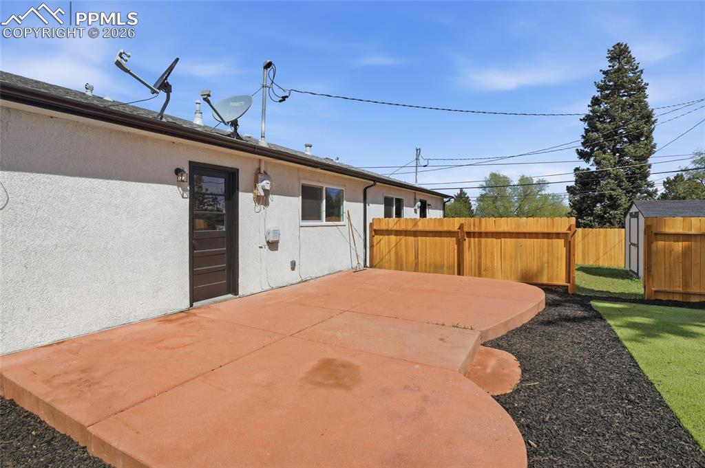 Image 32 of 44: The property features a private patio with a unique curved design, surround