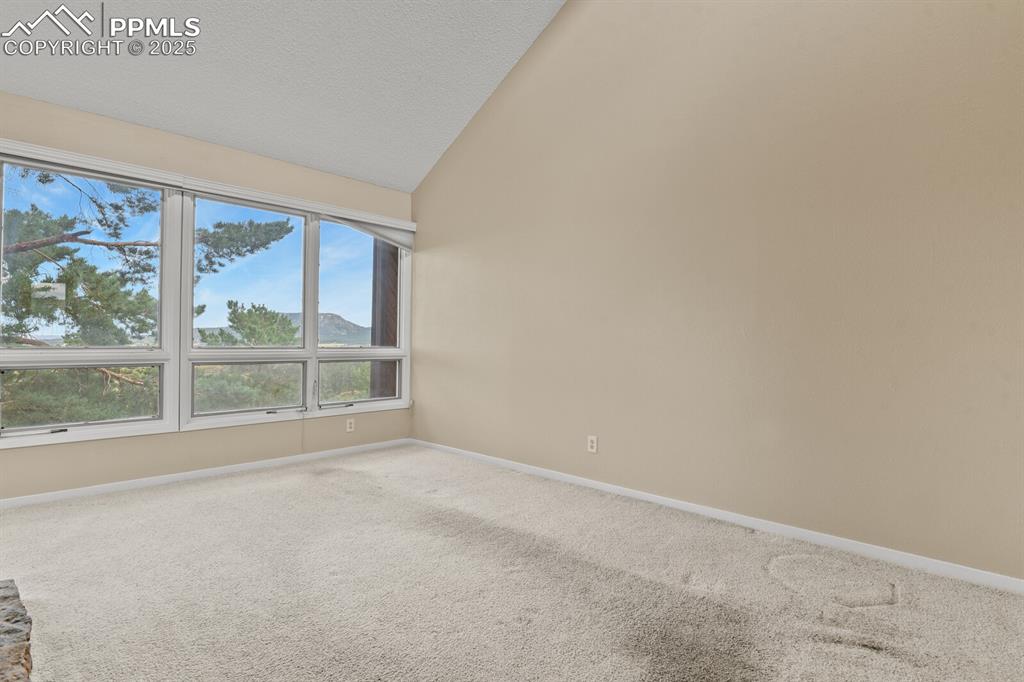 Image 5 of 35: Living room on the main level with large window and amazing views!
