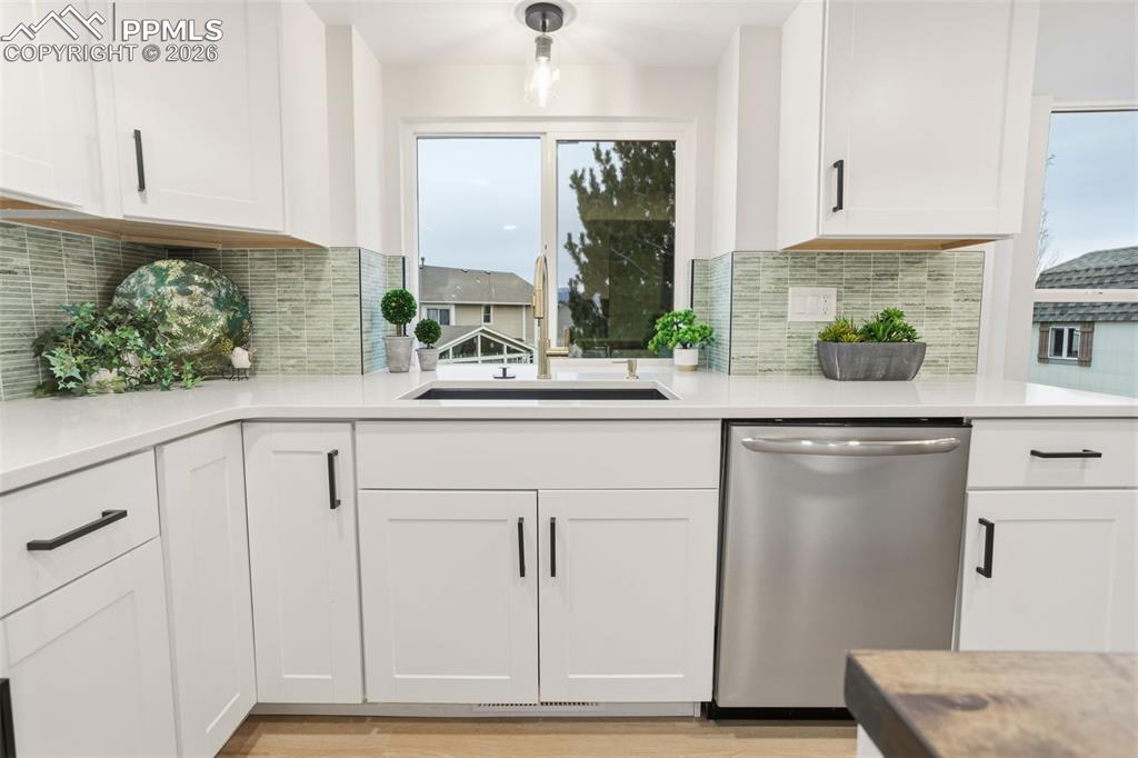 Image 12 of 46: Sunlit Sink View Overlooking Backyard