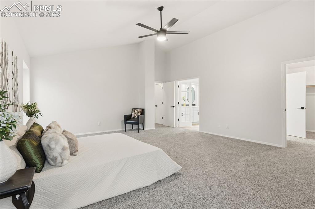 Image 26 of 46: Expansive Primary Boasts Vaulted Ceilings and Plenty of Natural Light.