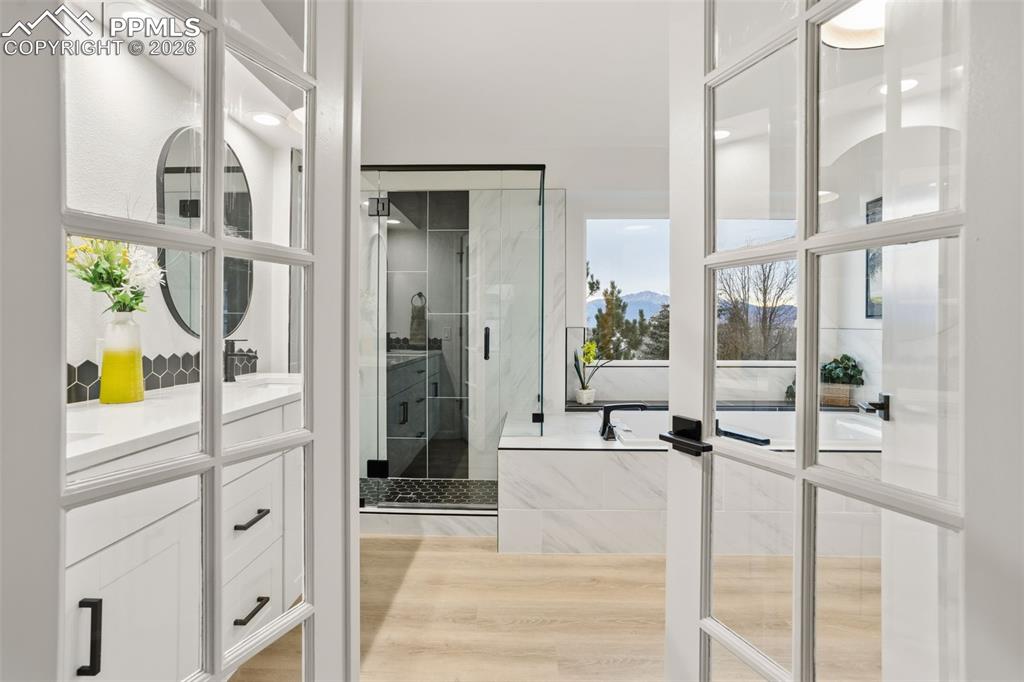 Image 28 of 46: Enter the Spa-Inspired Ensuite Through Elegant French Doors