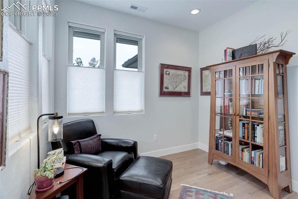 Image 16 of 28: Sitting room featuring wood finished floors and baseboards