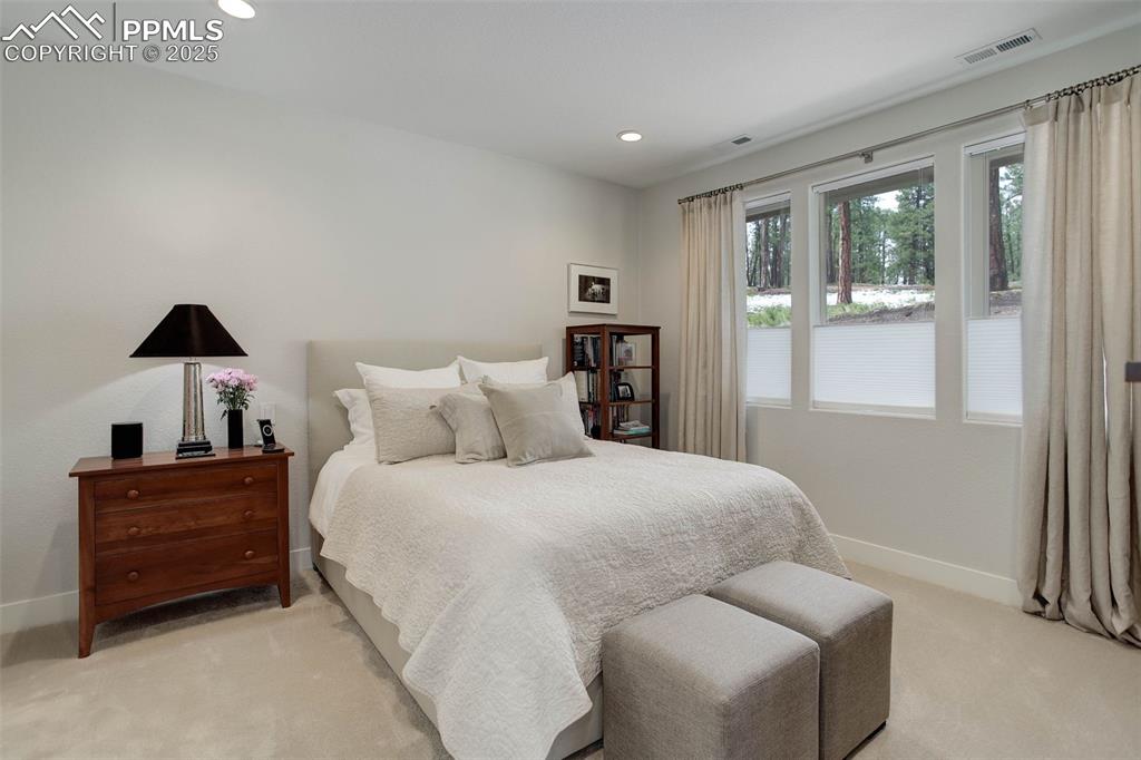 Image 18 of 28: Bedroom featuring baseboards, light carpet, and recessed lighting