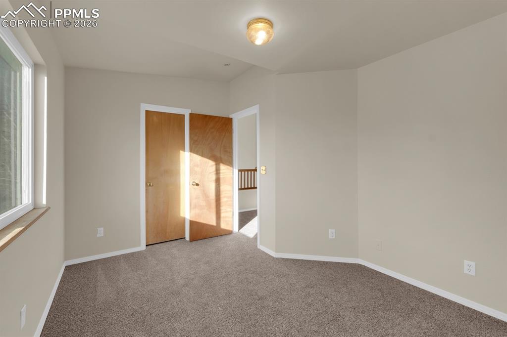 Image 17 of 41: Bedroom with carpet flooring and baseboards