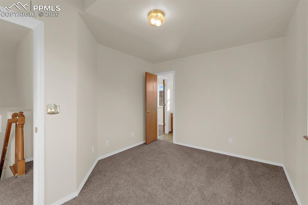 Image 18 of 41: Carpeted bedroom with baseboards