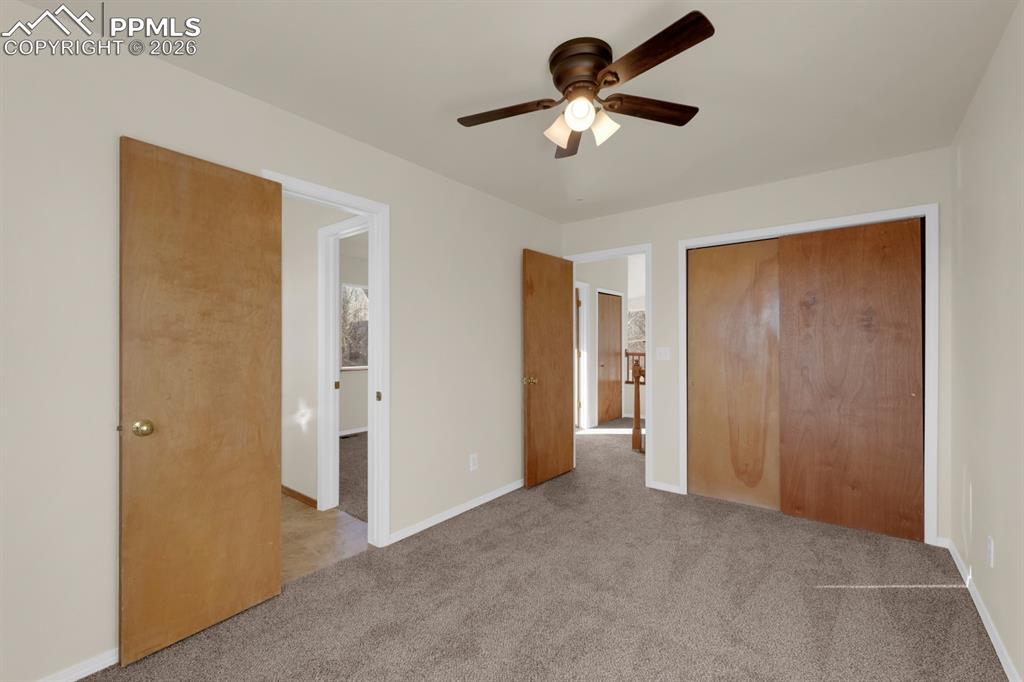 Image 20 of 41: Bedroom featuring light carpet, a closet, and a ceiling fan