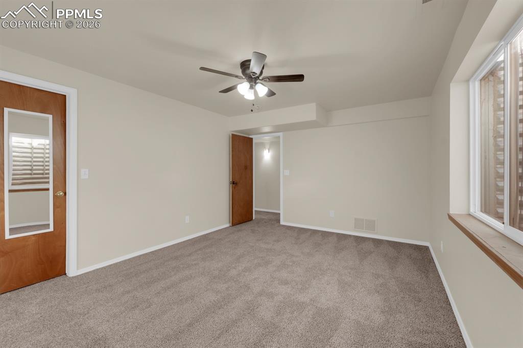 Image 22 of 41: Bedroom with carpet floors and a ceiling fan