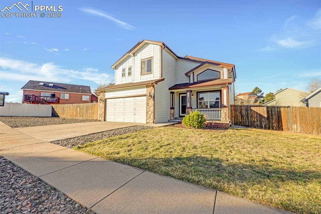 Image 31 of 41: Traditional home featuring driveway, an attached garage, and a porch