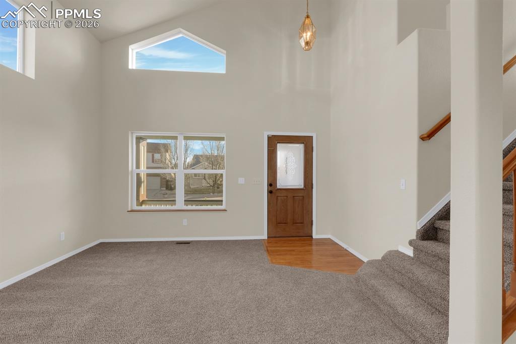Image 7 of 41: Entrance foyer featuring carpet flooring and a high ceiling
