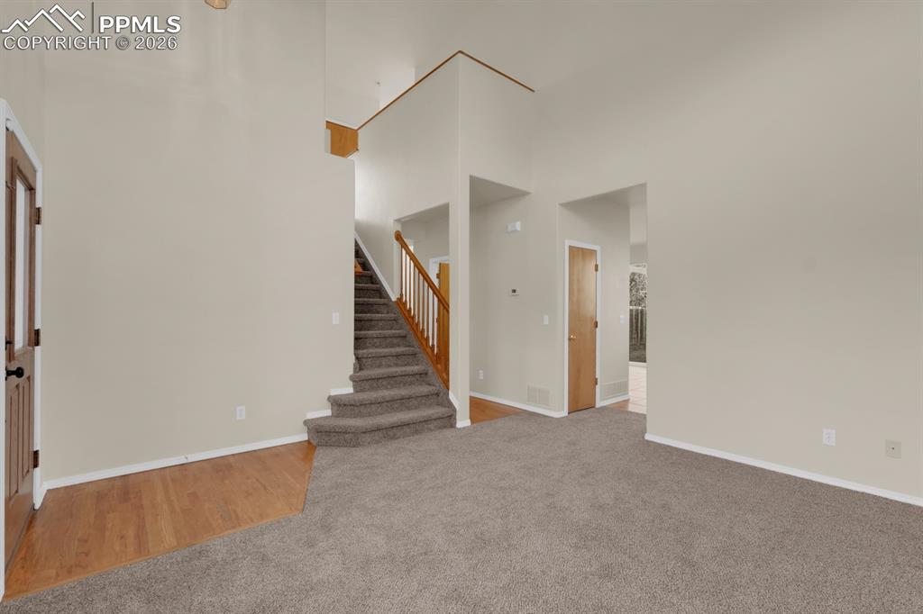 Image 8 of 41: Entry featuring wood and carpet flooring.