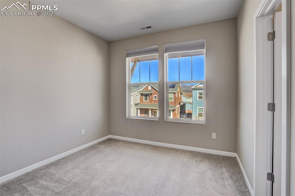 Image 26 of 39: Unfurnished room with carpet flooring, baseboards, and visible vents