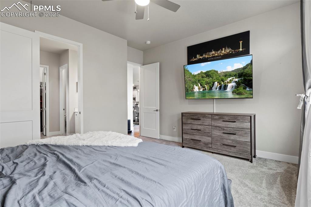 Image 14 of 38: Carpeted bedroom featuring a ceiling fan and baseboards