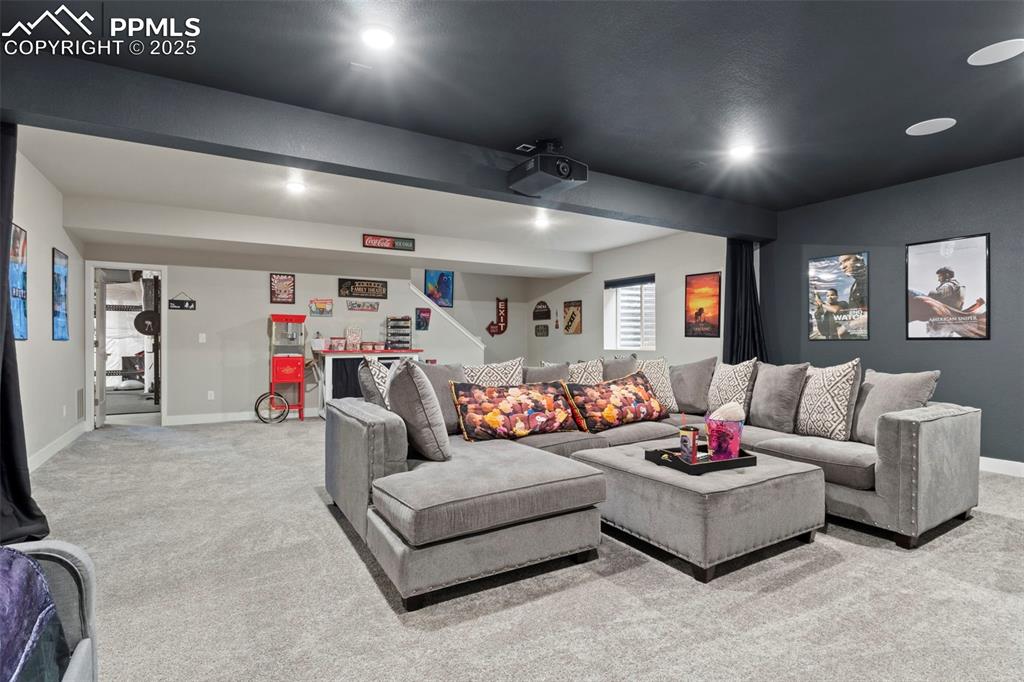 Image 19 of 38: Living area with baseboards, recessed lighting, and light carpet