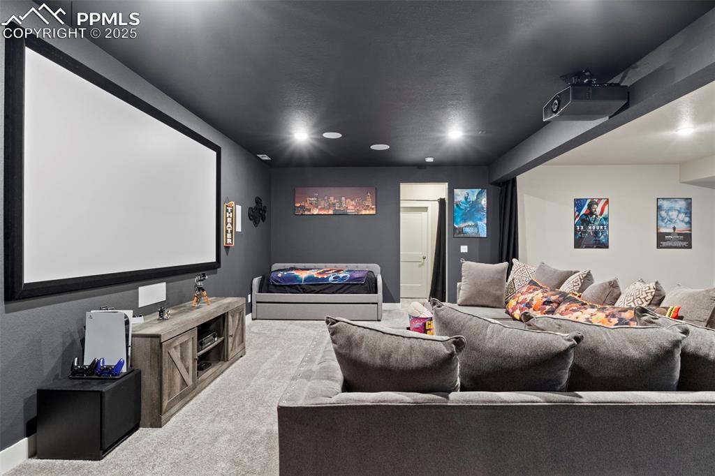 Image 21 of 38: Cinema room with recessed lighting, baseboards, and carpet floors