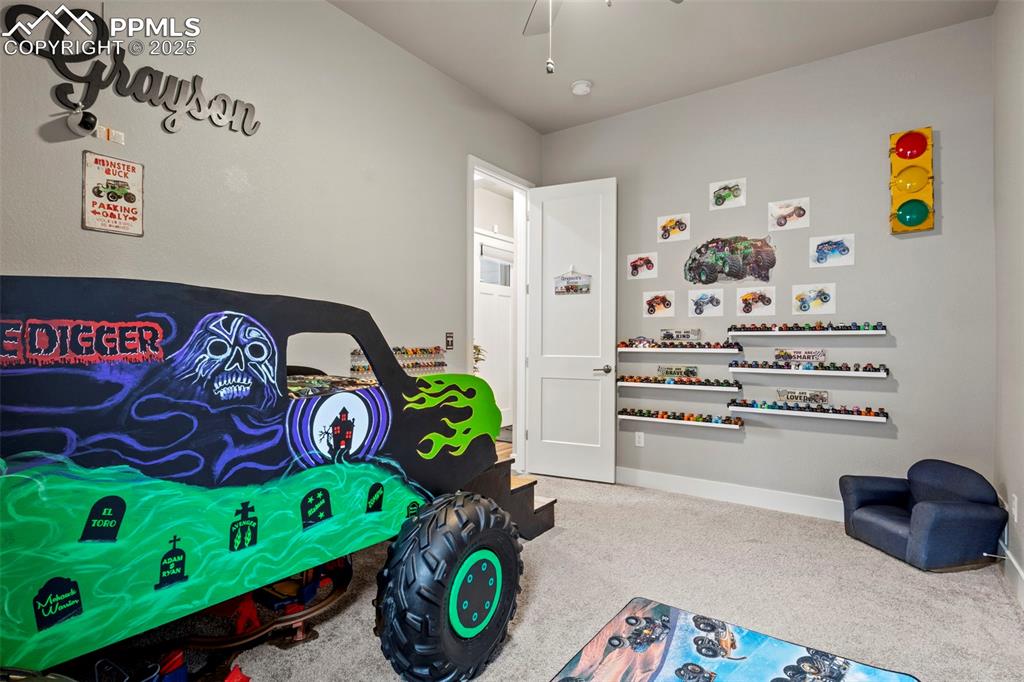 Image 25 of 38: Carpeted bedroom with ceiling fan and baseboards
